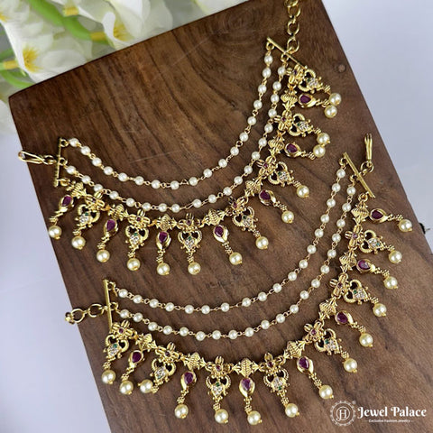 Gold and pearl jewelry set on a wooden surface with 'Jewel Palace' branding.