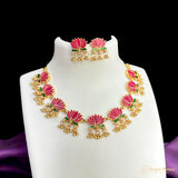 Jewelry set with pink floral design on a white stand