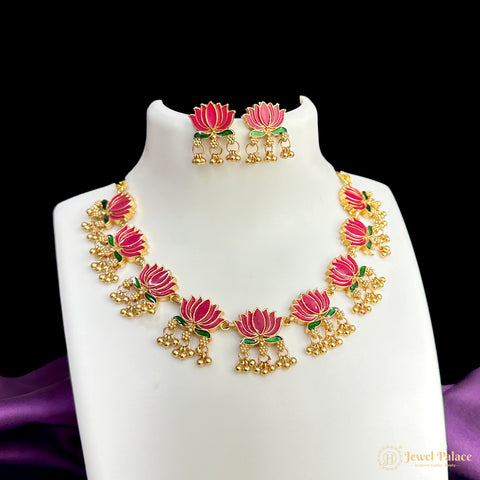Jewelry set with pink floral design on a white stand