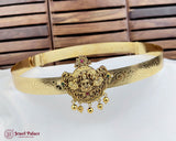 Gold headband with intricate designs and a central emblem on a white surface with wooden background