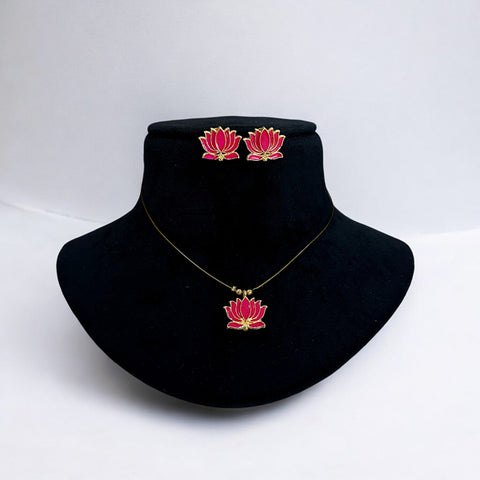 Jewelry set with pink lotus design on a black velvet stand against a white background