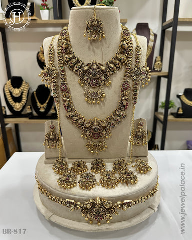 A traditional South Indian bridal jewellery set displayed on a mannequin, featuring gold-plated designs with pearl and kemp stone embellishments.