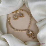 Gold necklace and earrings on a white fabric background with 'Jewel Palace' branding.