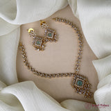 Gold necklace and earrings on a beige fabric background with 'Jewel Palace' branding.