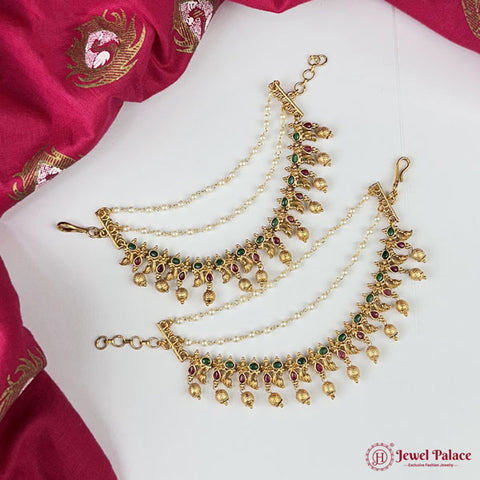 Gold necklace with green and red stones on a white fabric background, brand 'Jewel Palace' visible.