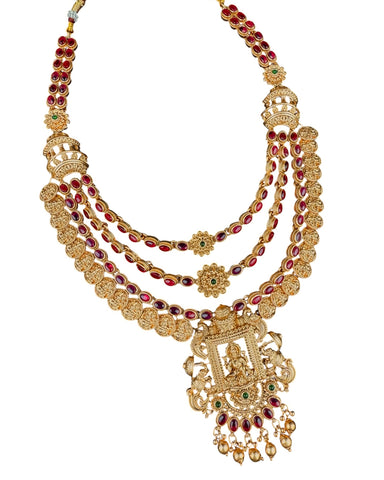 Gold necklace with red and green gemstones on a white background