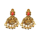 Pair of gold earrings with red stones on a white background