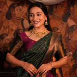 Woman in traditional attire with jewelry against a mural background