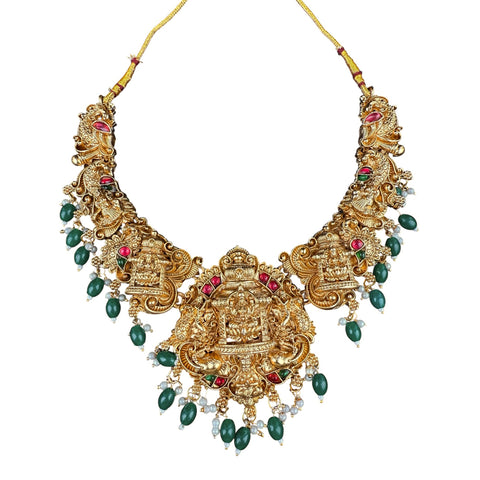 Ornate gold necklace with green and red stones on a white background