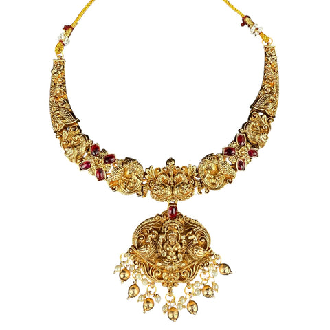 Gold necklace with intricate designs and red stones on a white background