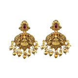 Pair of gold earrings with red gemstones and pearl-like beads on a white background
