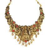 Ornate gold necklace with red stones on a white background