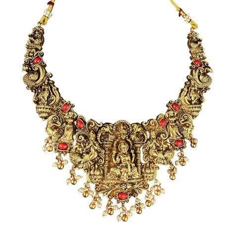 Ornate gold necklace with red stones on a white background