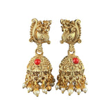 Gold earrings with red stones and pearl-like beads on a white background