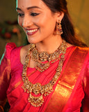 Woman wearing traditional gold jewelry and a red saree with a blurred background