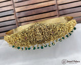Gold necklace with green beads on a white surface, brand 'Jewel Palace' visible
