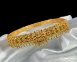 Gold headband with decorative elements on a white fabric background