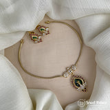 Gold necklace and earrings on a beige stand with 'Jewel Palace' branding.