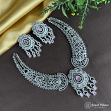 Ornate necklace and earrings set on a dark surface with 'Jewel Palace' branding.