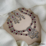 Jewelry set with necklace, earrings, and ring on a beige surface with 'Jewel Palace' branding.