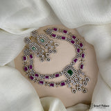 Ornate necklace with gemstones on a white fabric background