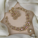 Delicate gold necklace with pink stones on a neutral background