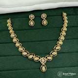 Gold necklace and earrings set on a green fabric background with 'Jewel Palace' branding.