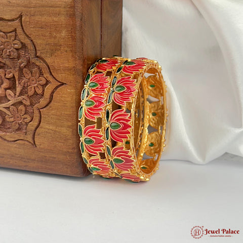 Gold bangles with red and green floral design on a white fabric background, branded 'Jewel Palace'.