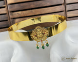 Gold headband with decorative elements on a white mannequin head against a wooden background