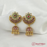 Gold earrings with gemstones on a white fabric background, featuring 'Jewel Palace' branding.