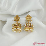 Inspired by temple jewelry art, these handcrafted jhumkas feature intricate carvings, sparkling ruby stones, and elegant pearl details. Suitable for festive occasions.