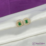 Gold earrings with green gemstones on a white and purple fabric background, featuring the brand 'Jewel Palace'.