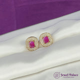 Gold earrings with pink gemstones on a white surface with a purple background, branded 'Jewel Palace'.