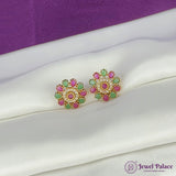 Pair of gold earrings with pink and green gemstones on a white surface with a purple background, featuring the brand 'Jewel Palace'.