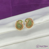 Ornate earrings with green and pink stones on a white fabric background, brand 'Jewel Palace' visible.