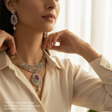 Woman wearing a luxurious necklace and earrings with a blurred background