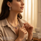 Woman wearing a necklace and earrings in a softly lit room