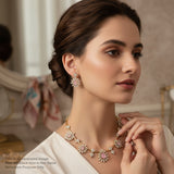 Woman wearing a floral necklace and earrings in an elegant setting