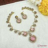 Jewelry set with pink stones on a white fabric background