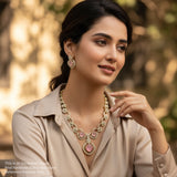 Woman wearing a necklace and earrings with a blurred natural background