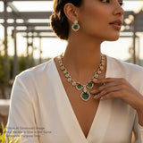 Woman wearing a green and gold necklace with a blurred outdoor background