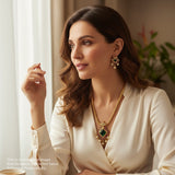 Woman wearing elegant jewelry indoors with a neutral background
