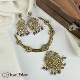 Gold jewelry set with purple stones on a white fabric background, featuring 'Jewel Palace' branding.