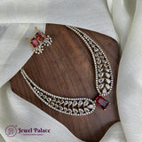 Jewelry set with necklace and earrings on a wooden surface, featuring 'Jewel Palace' brand.