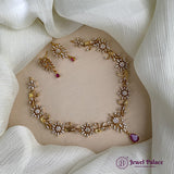 Gold necklace and earrings on a white fabric background with 'Jewel Palace' branding.