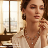 Woman wearing a gold necklace and earrings in a softly lit room.