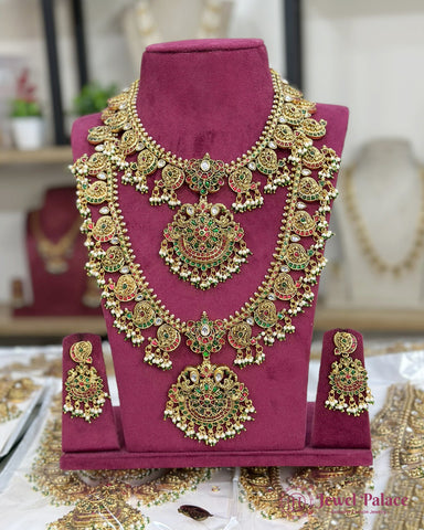 Ornate gold necklace with green stones on a purple stand, with 'Jewel Palace' branding.