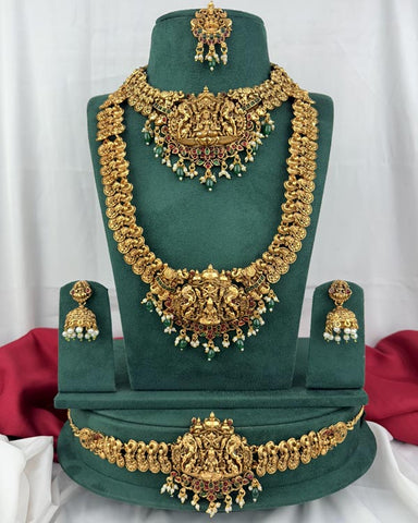 Gold necklace set with earrings on a green mannequin against a white background