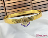 Gold headband with decorative elements on a white fabric background