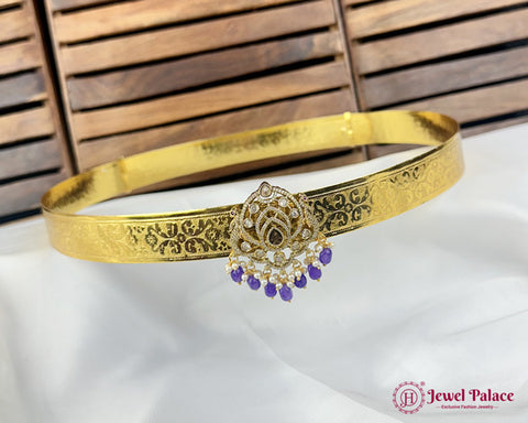 Gold headband with decorative elements on a white fabric background